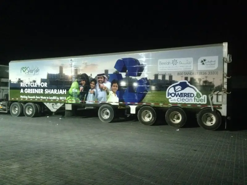 Green campaign graphics on a long vehicle