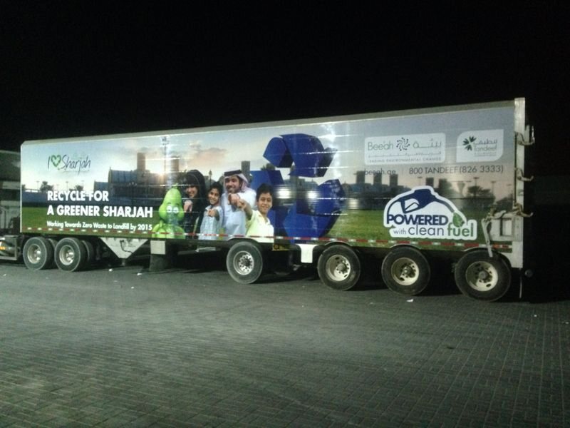 Green campaign graphics on a long vehicle